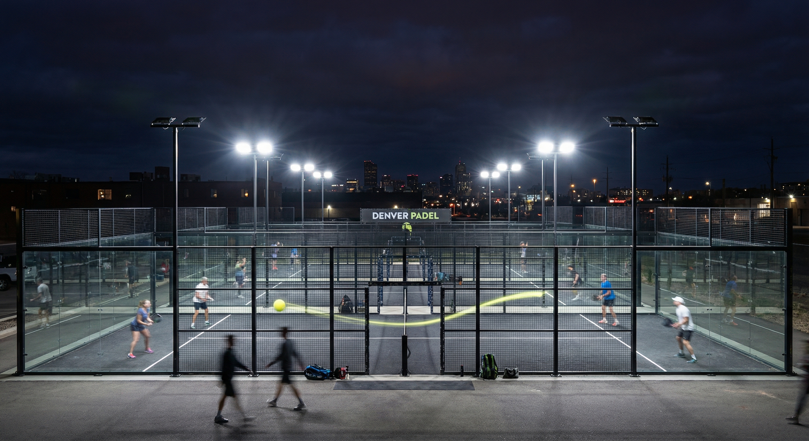 dramatic night shot of a Denver padel facility illuminated by bright LED floodlights