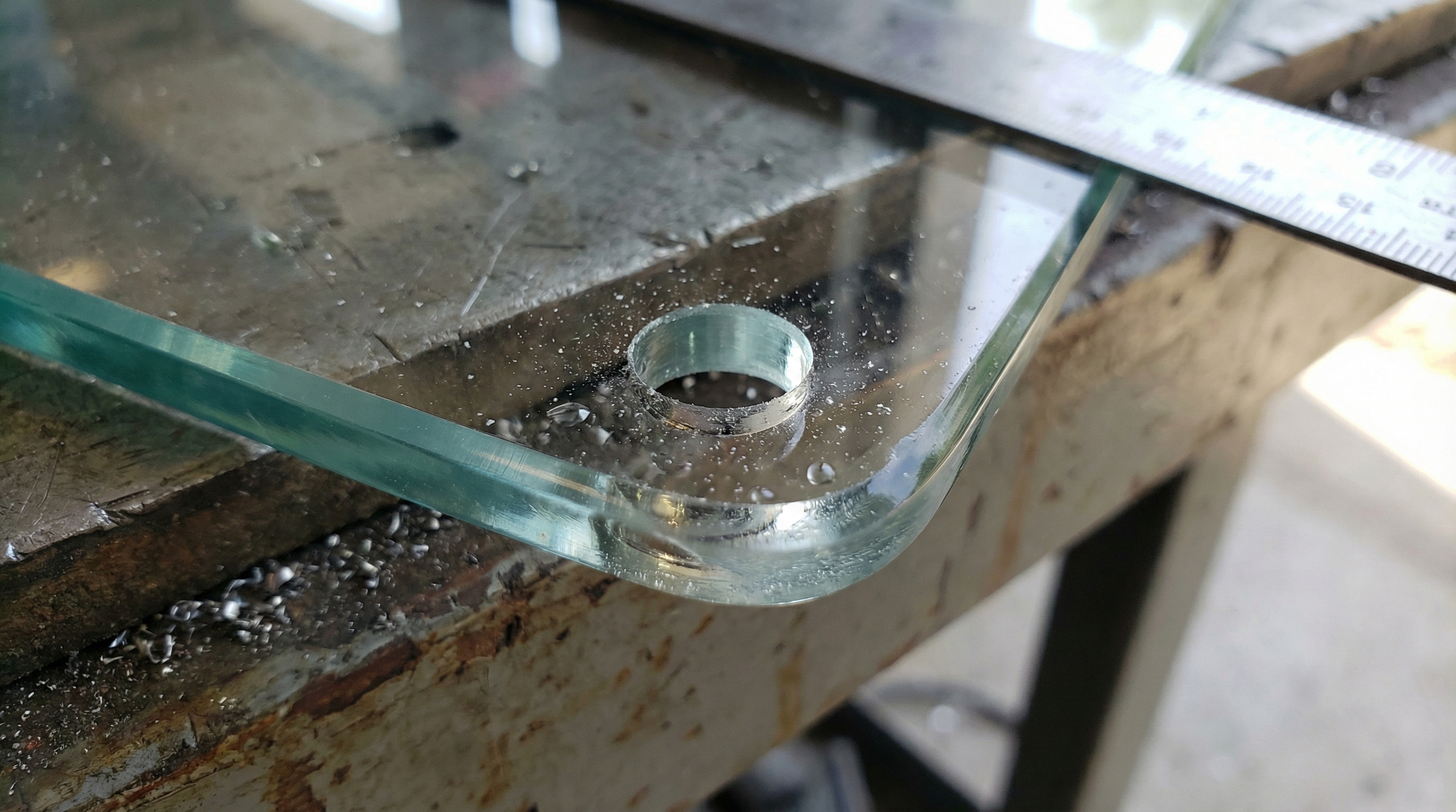 Macro shot of glass edge with drilled hole