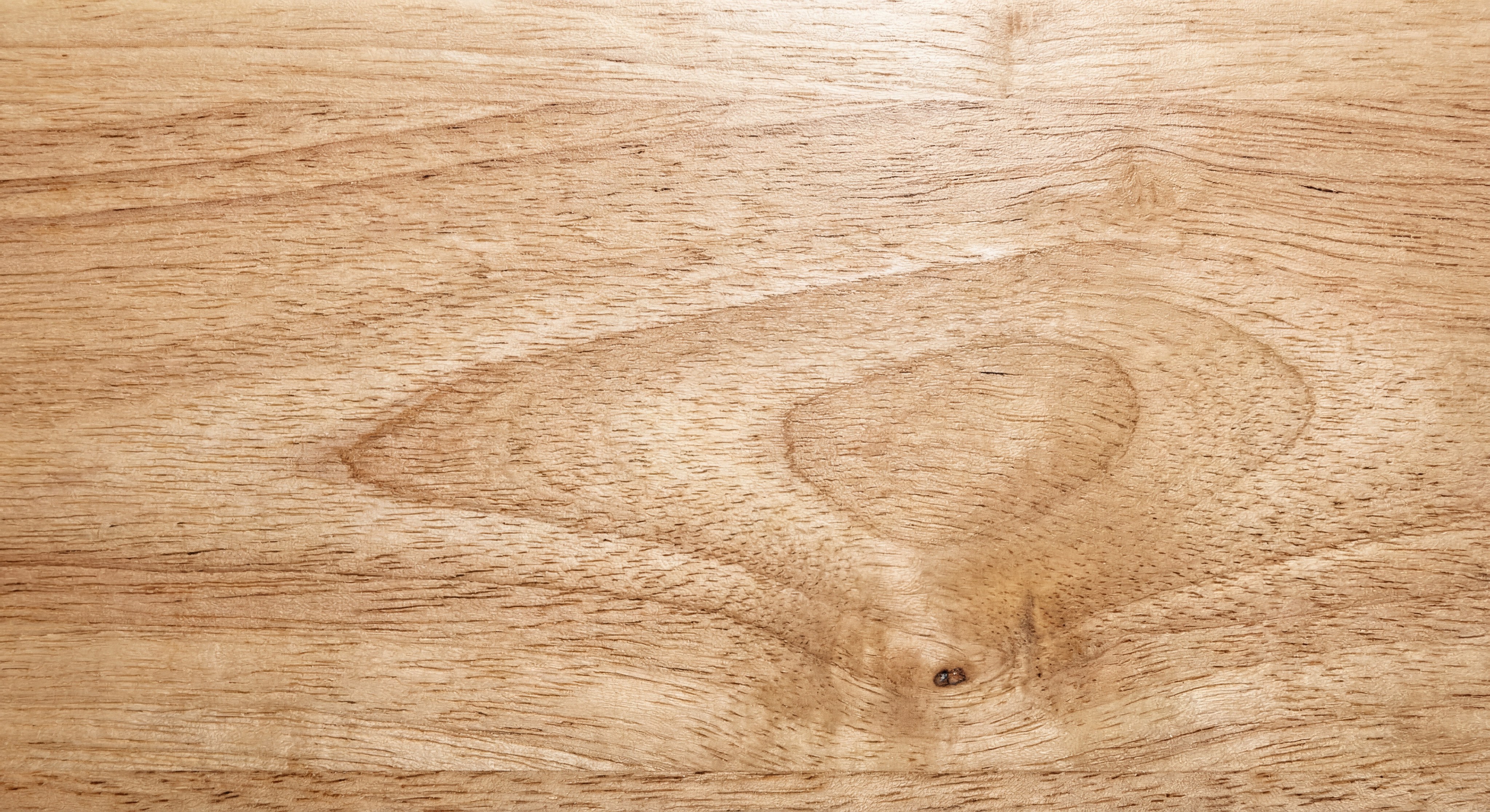 Macro shot of premium rubberwood grain with smooth satin finish