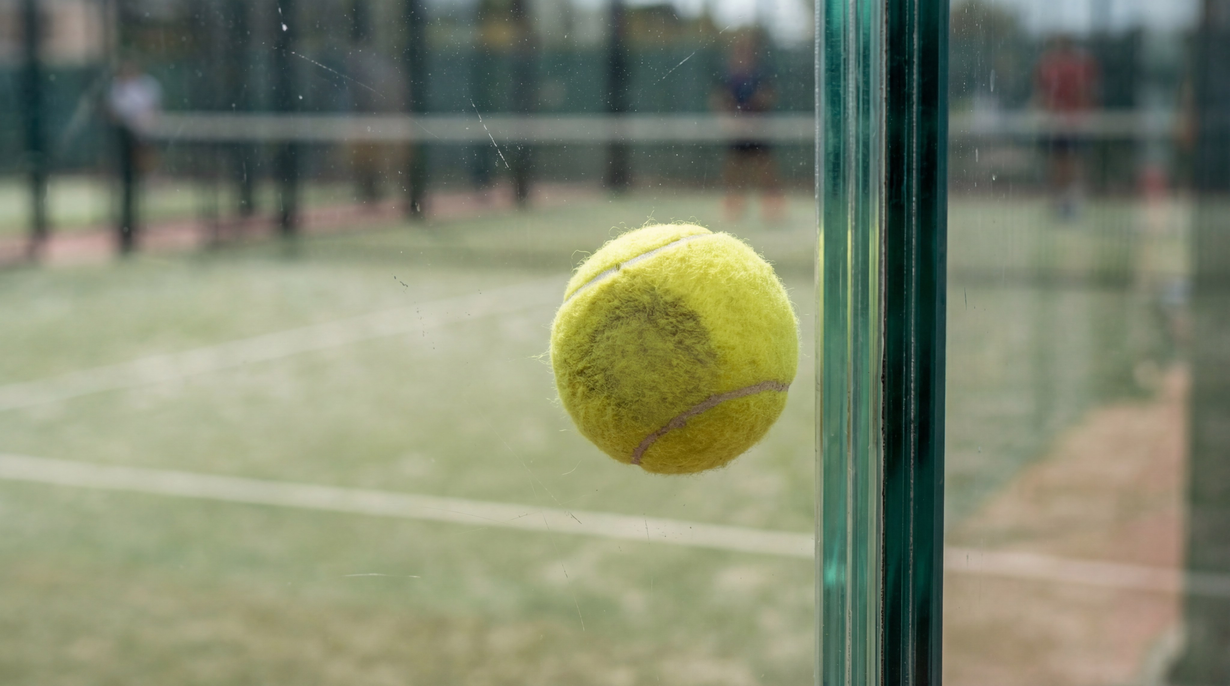 padel ball glass impact macro
