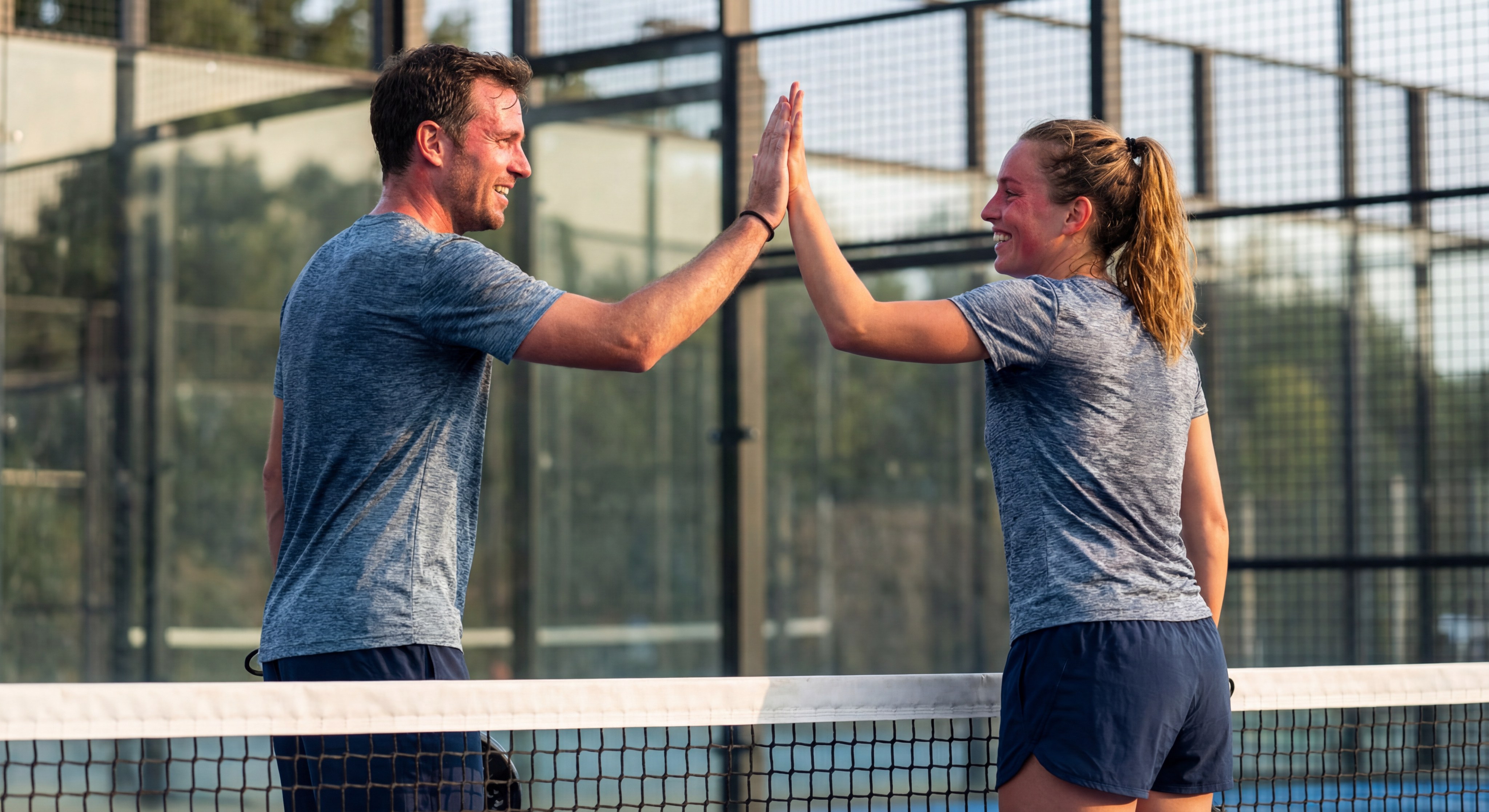 padel players high five celebration