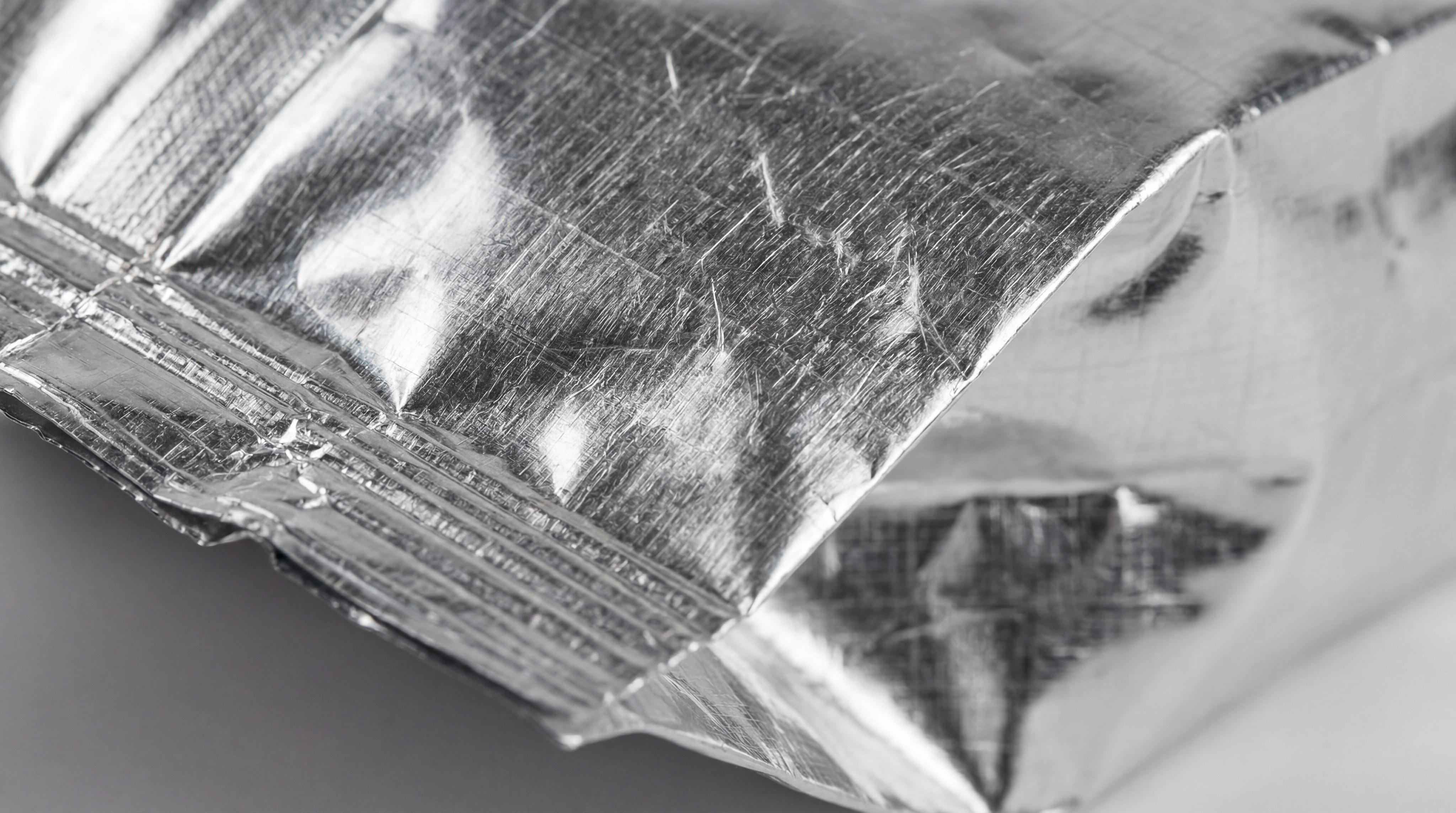 Close-up of a foil-lined bag providing UV protection packaging for roasted coffee beans.
