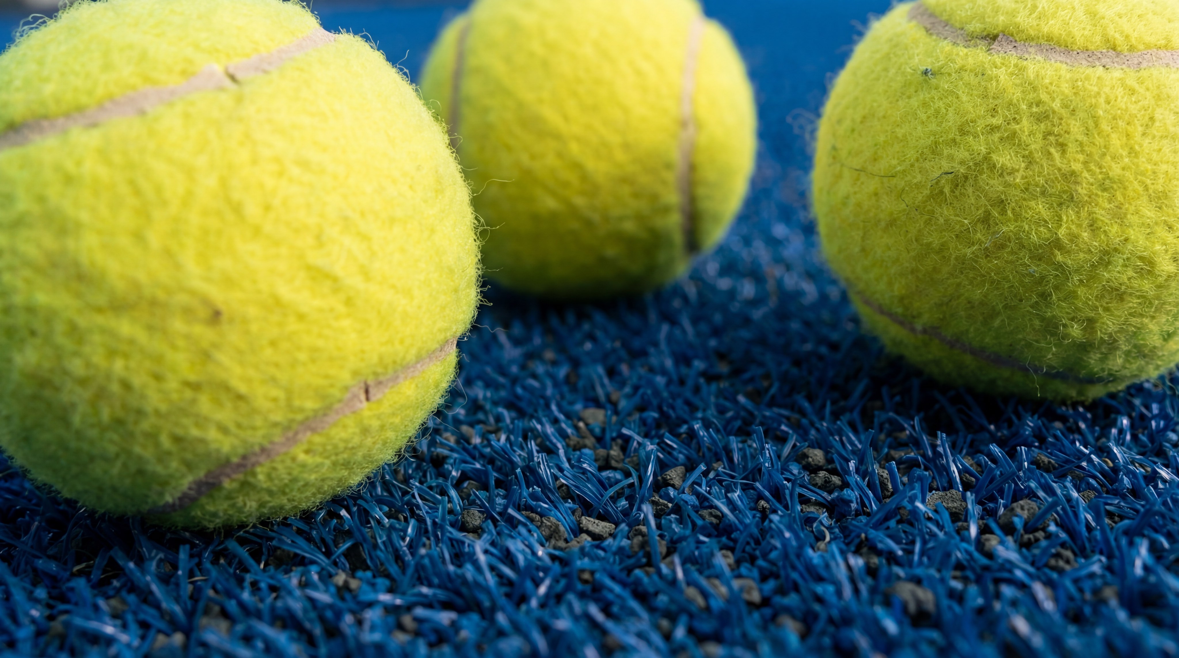 Photorealistic Macro Shot of Yellow Padel Balls on Blue Synthetic Turf