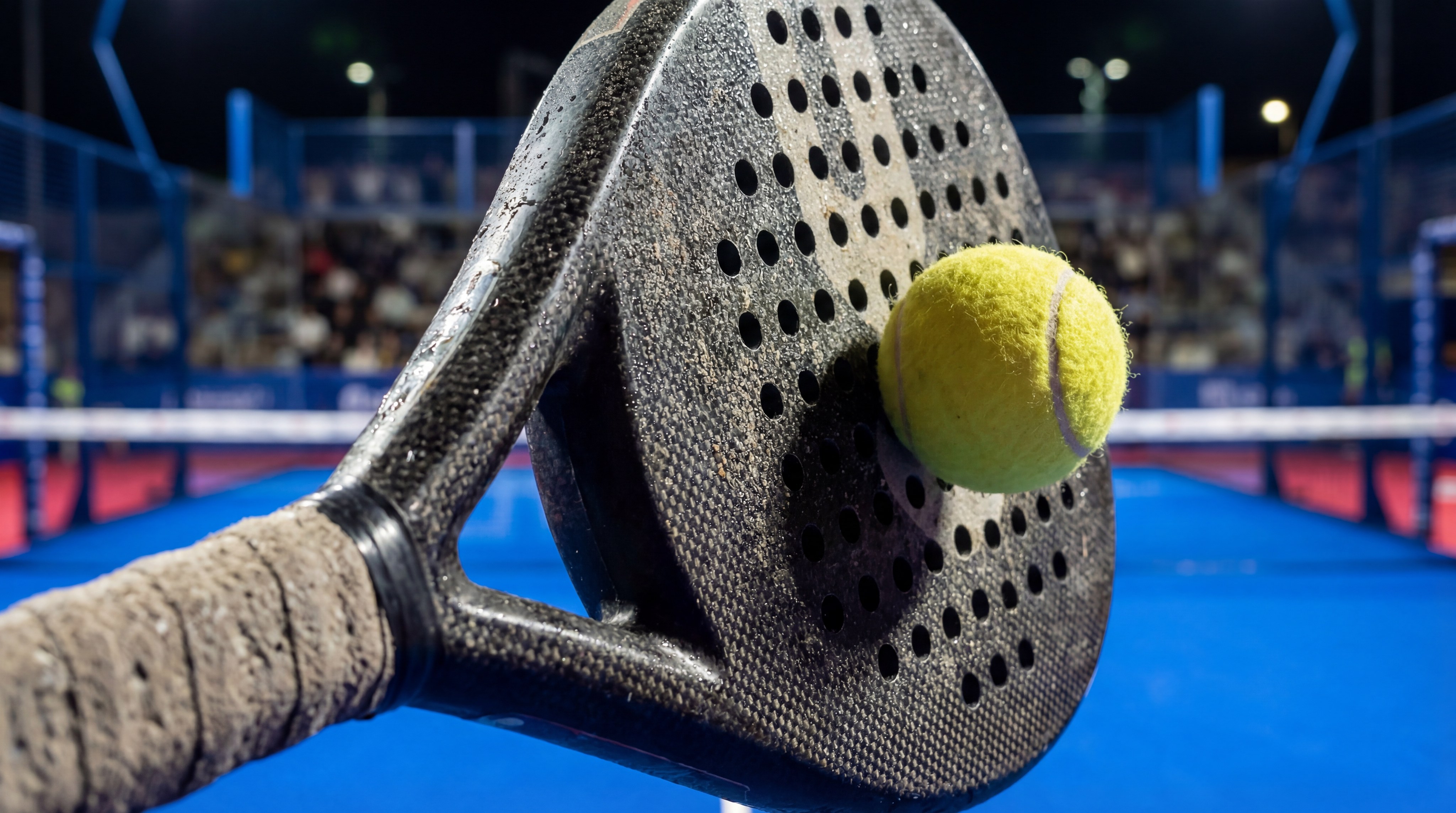 Padel racket ball impact closeup