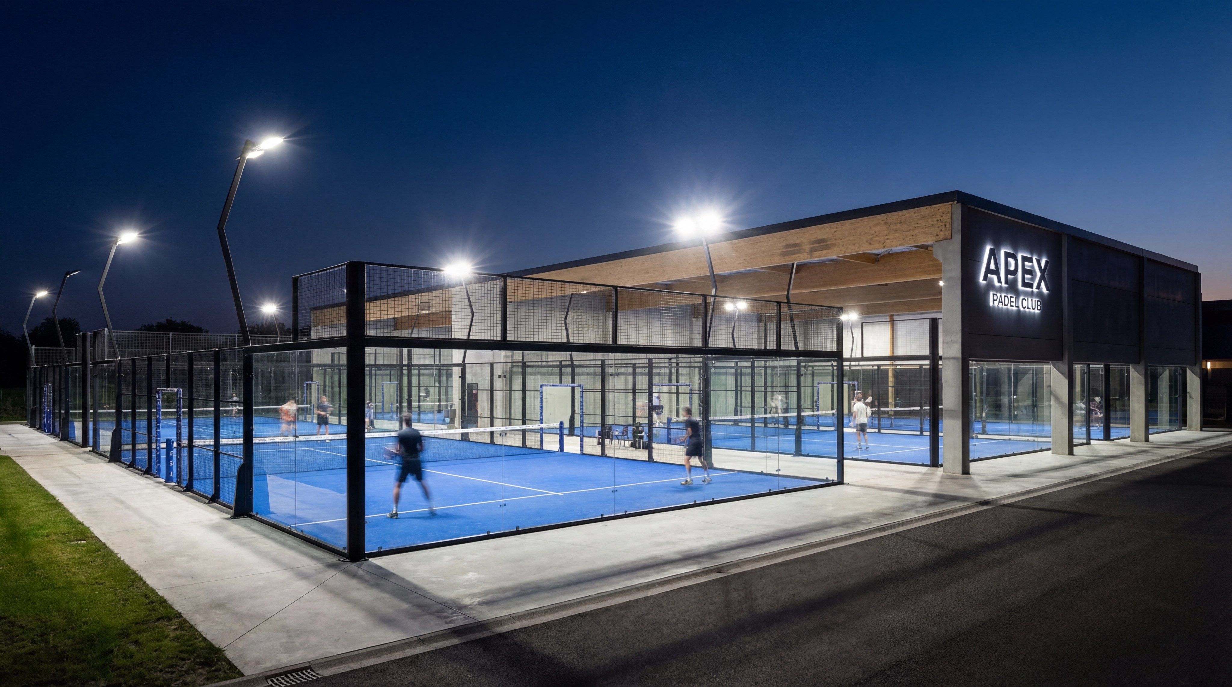 A dramatic night shot of a padel facility illuminated by powerful LED floodlights with no dark spots on the court surface.