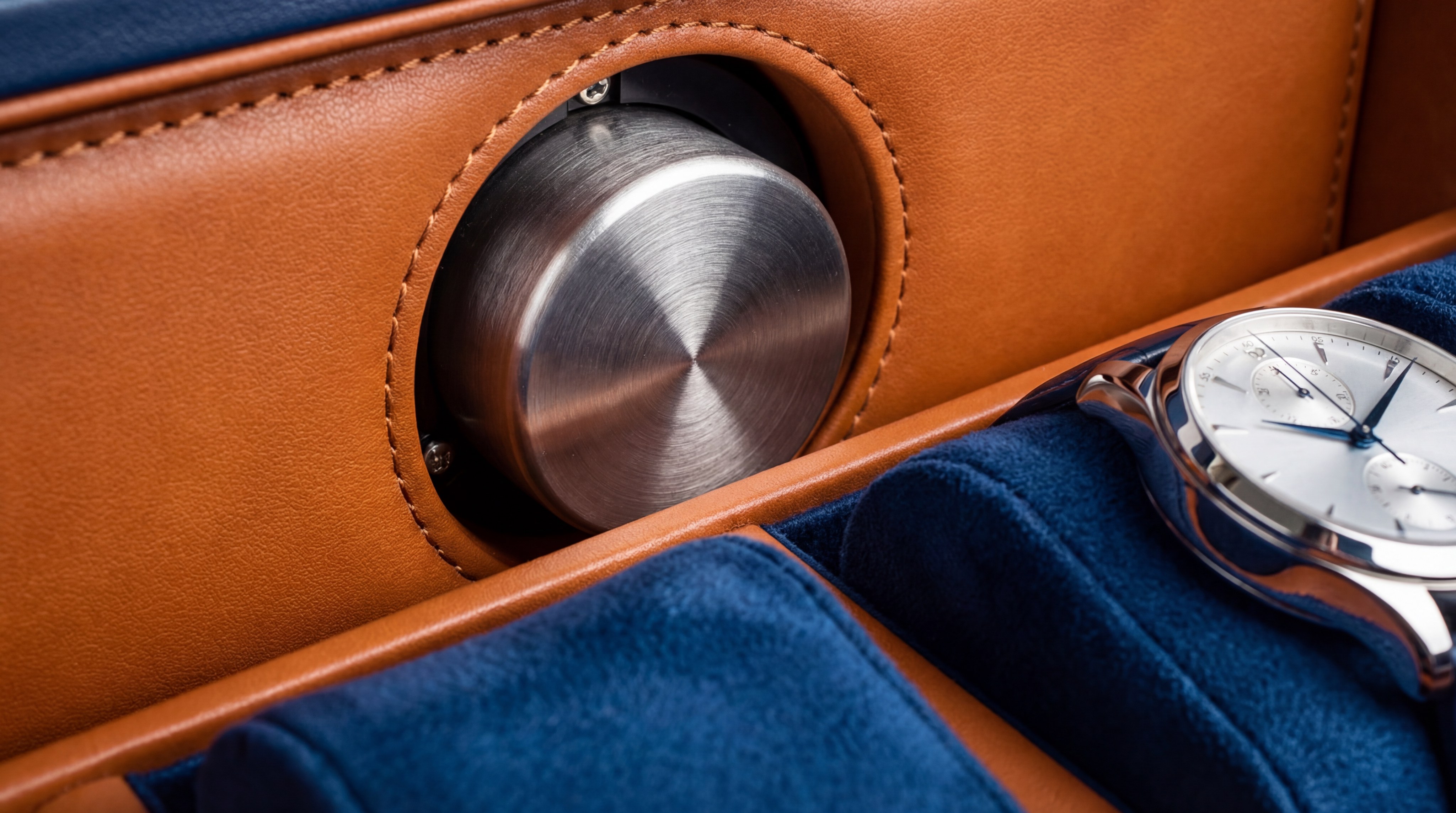 Macro closeup of a watch on a luxury winder cushion inside a safe
