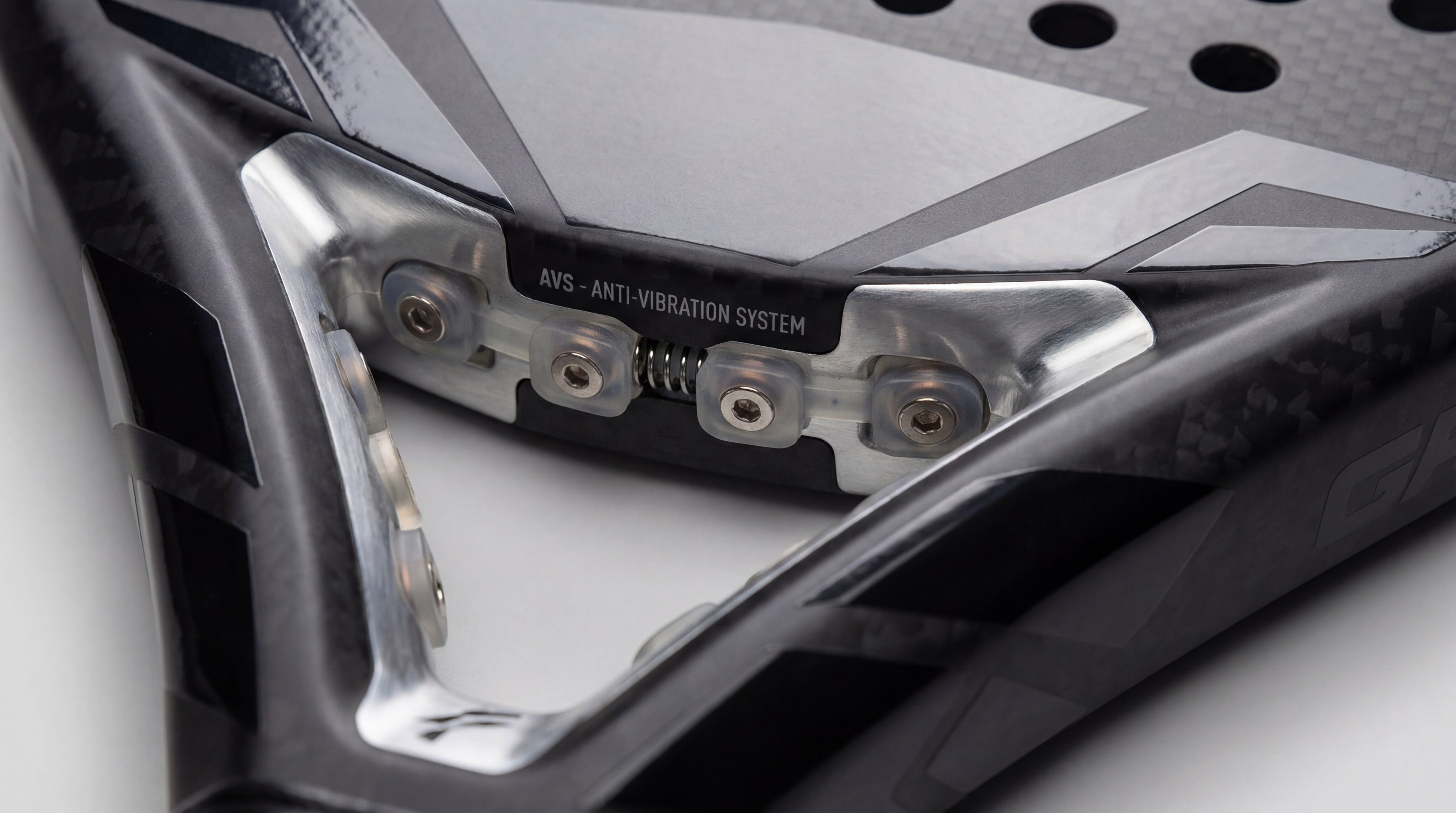 A photorealistic image focusing on the handle of a Siux racket, showing the Dual Pro Grip and the integrated anti-vibration dampeners in the holes.