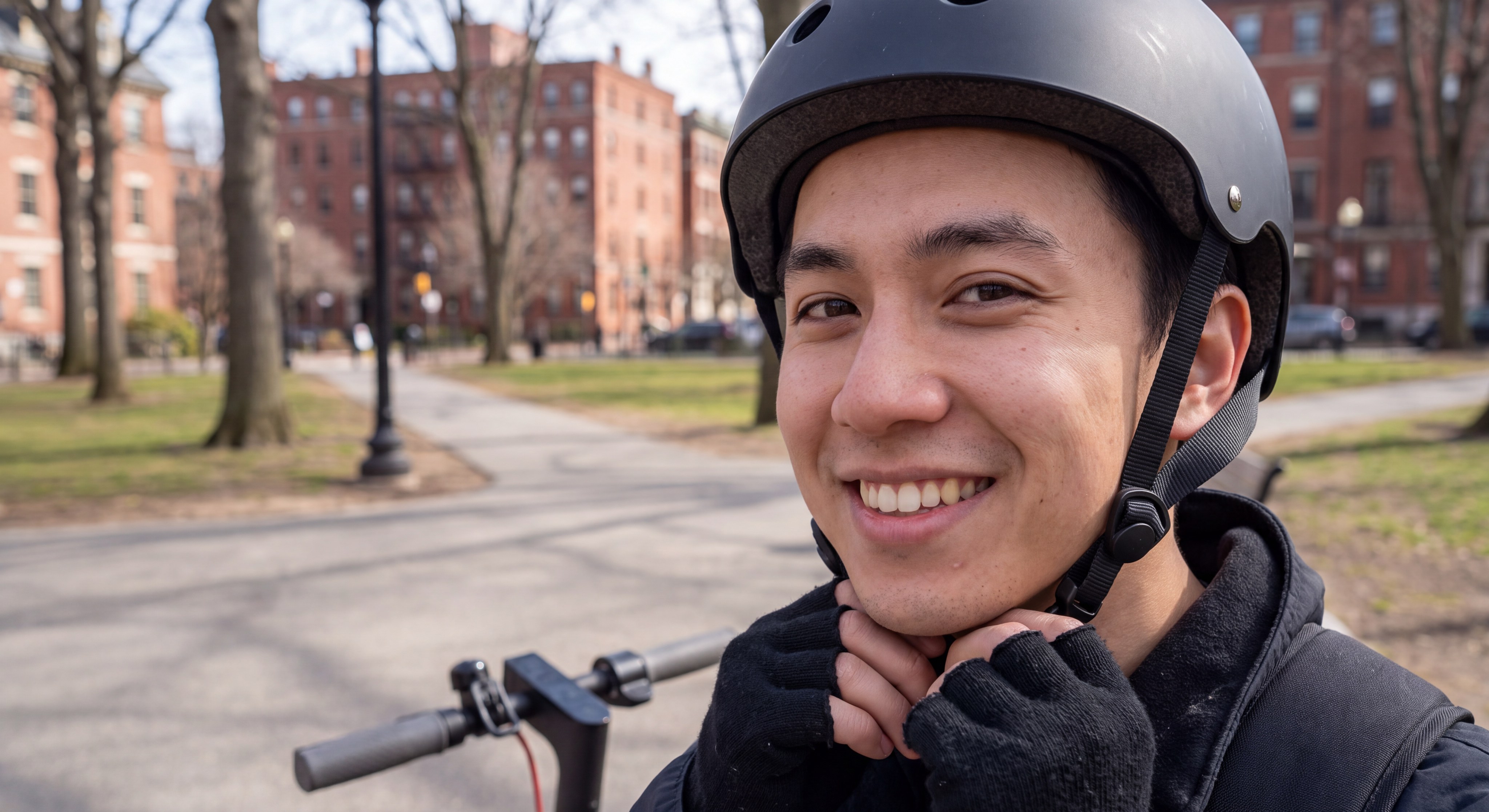 Young Professional with Electric Scooter in Boston Park (with helmet detail)