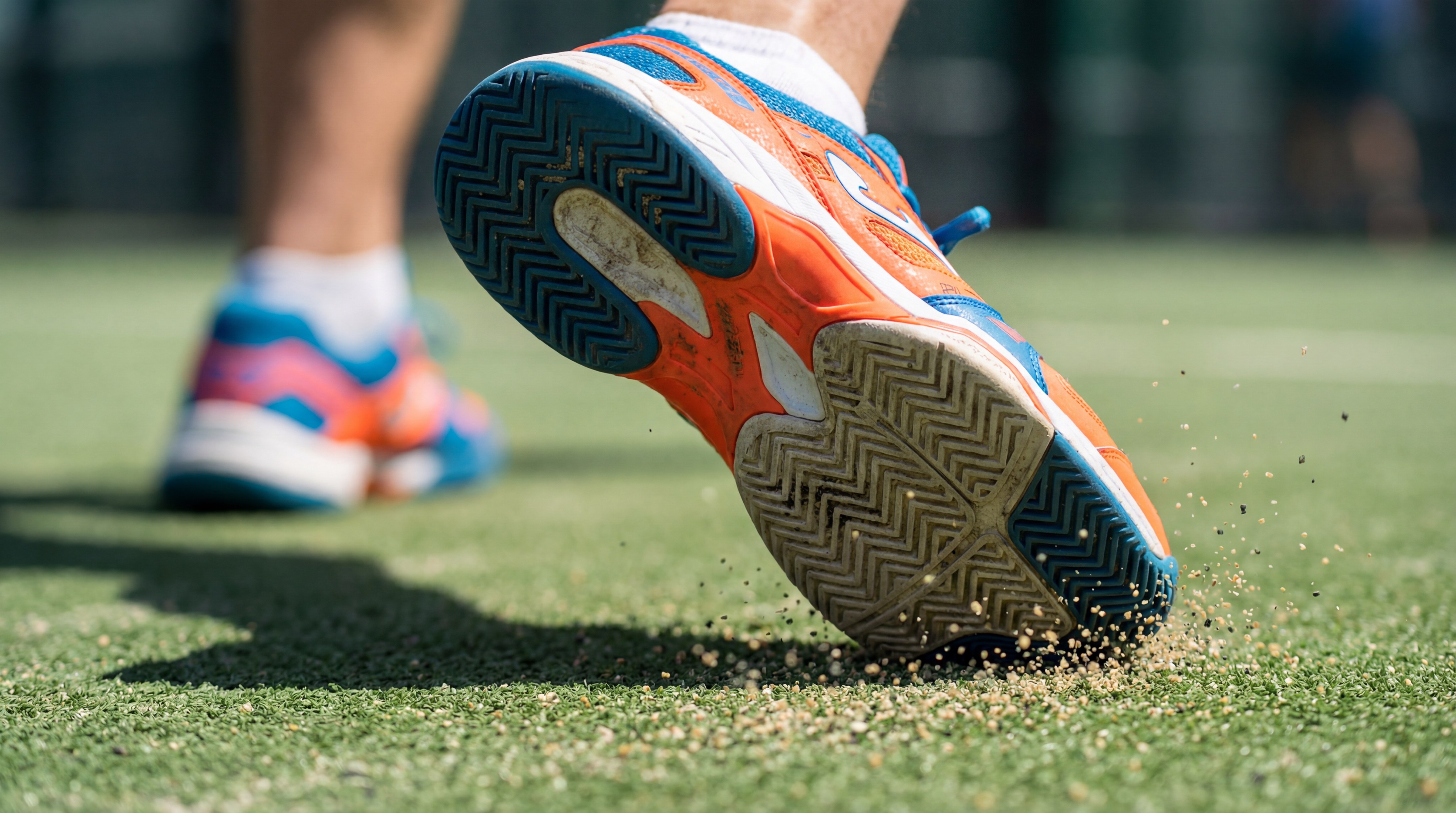 Detailed photography of sports shoes on a padel court surface