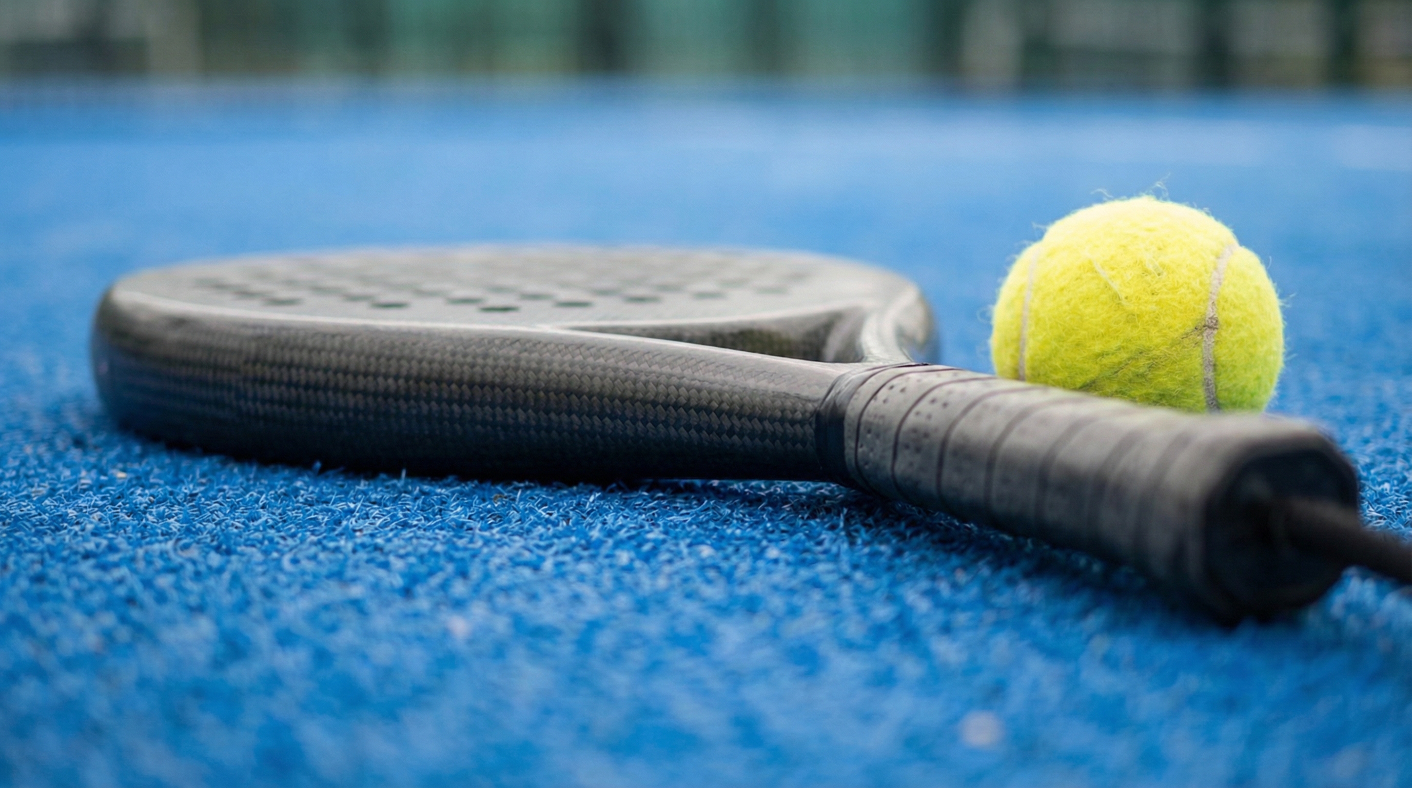 padel racket ball court closeup