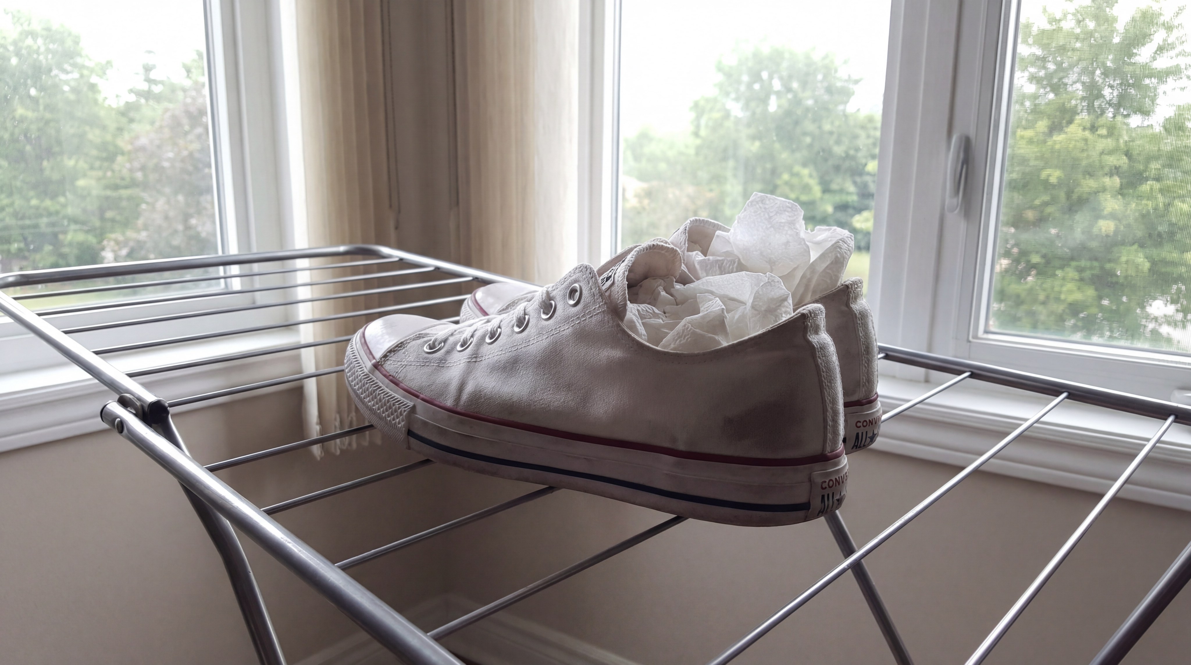 Alt Text: clean sneakers drying on a rack in a ventilated indoor area