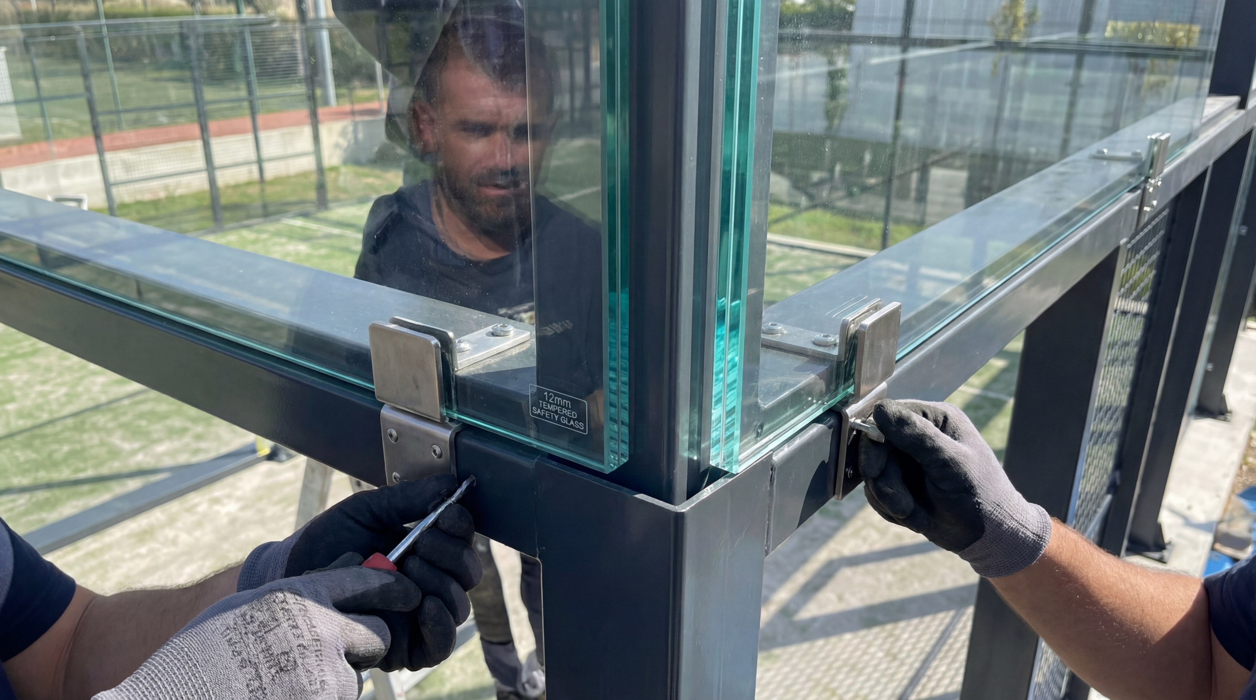 Close-up of a 12mm tempered safety glass panel being installed
