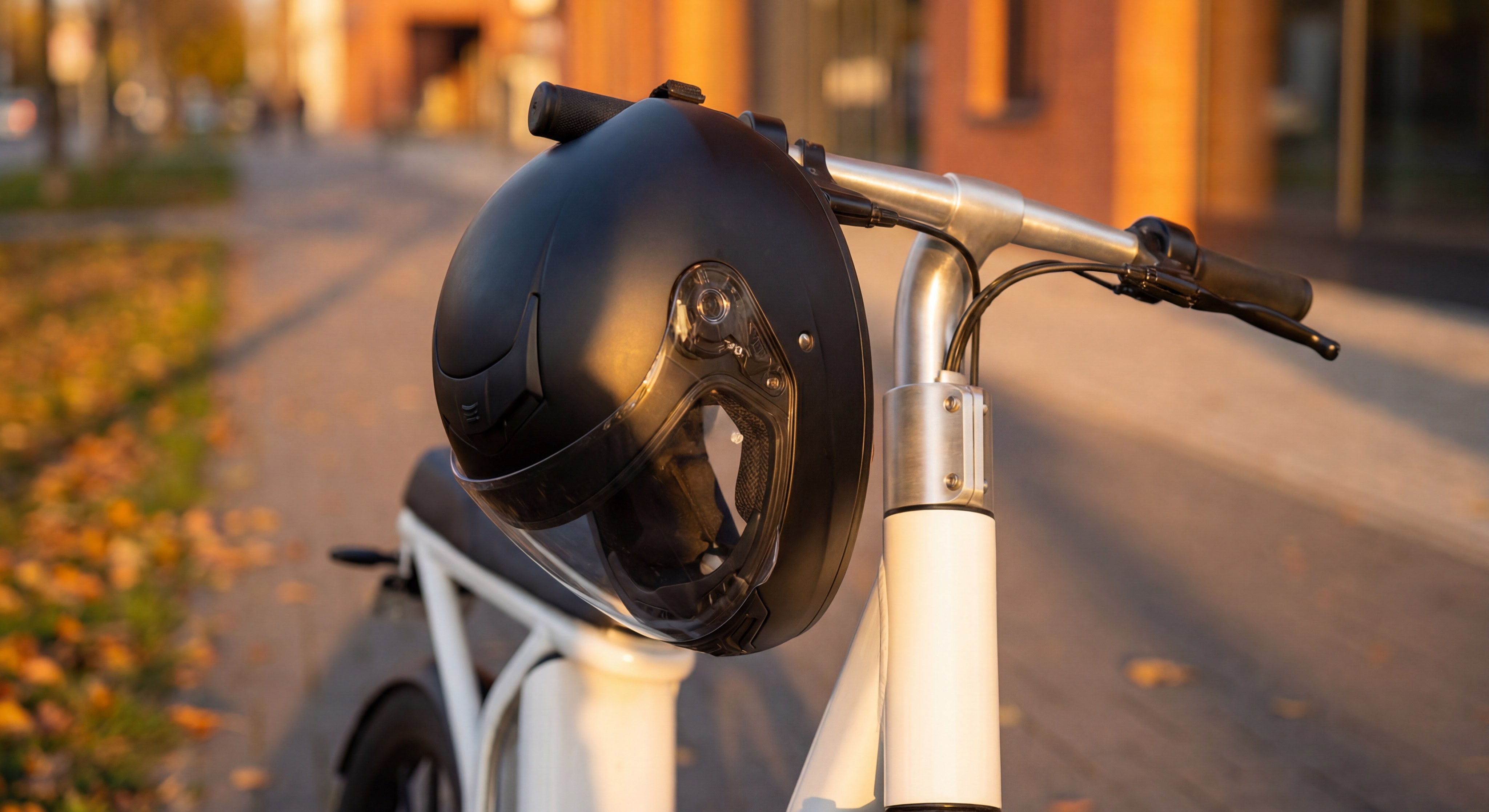 Close up of a safety helmet resting on an electric scooter handlebar