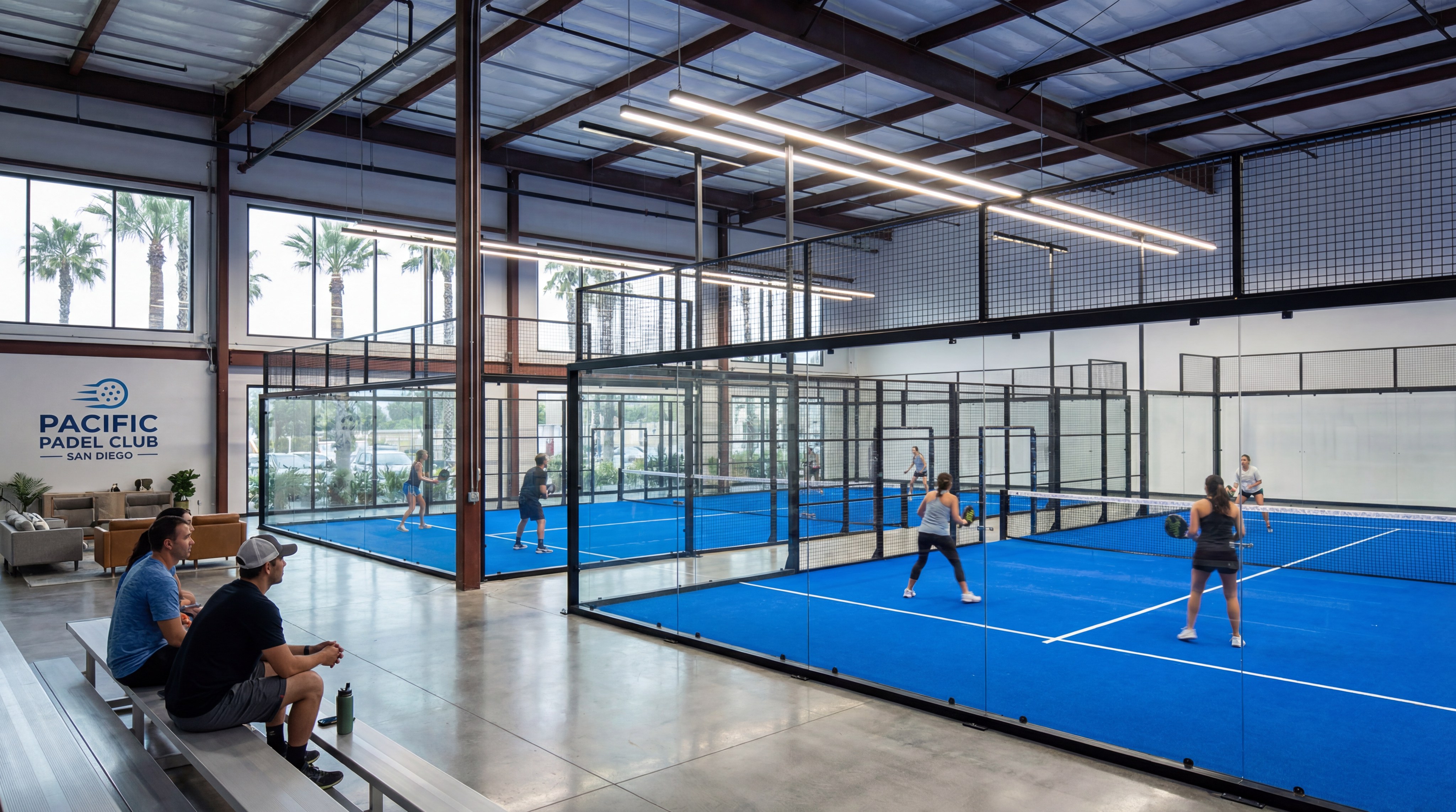Image: Professional indoor padel courts in San Diego featuring blue turf and glass walls