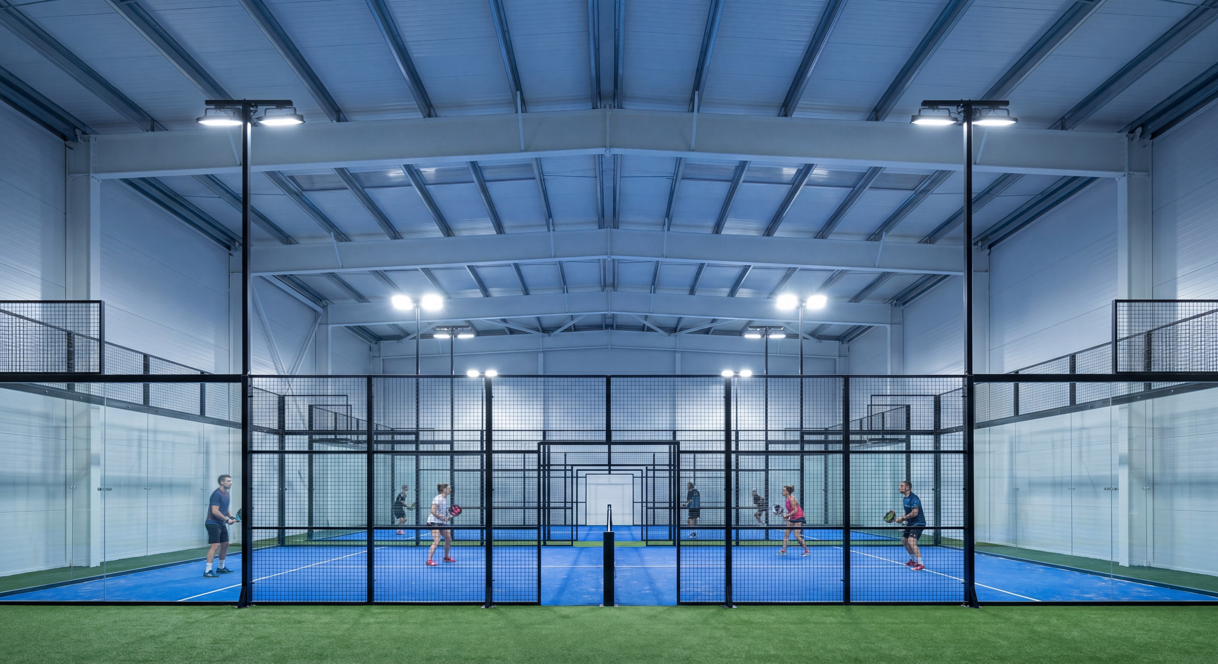 High-efficiency LED floodlights illuminating a professional indoor padel court